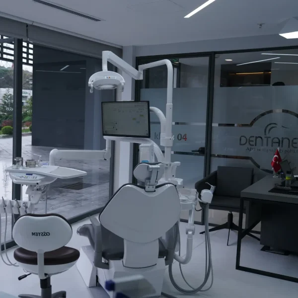 Modern dental clinic with chair, tools, and monitor.